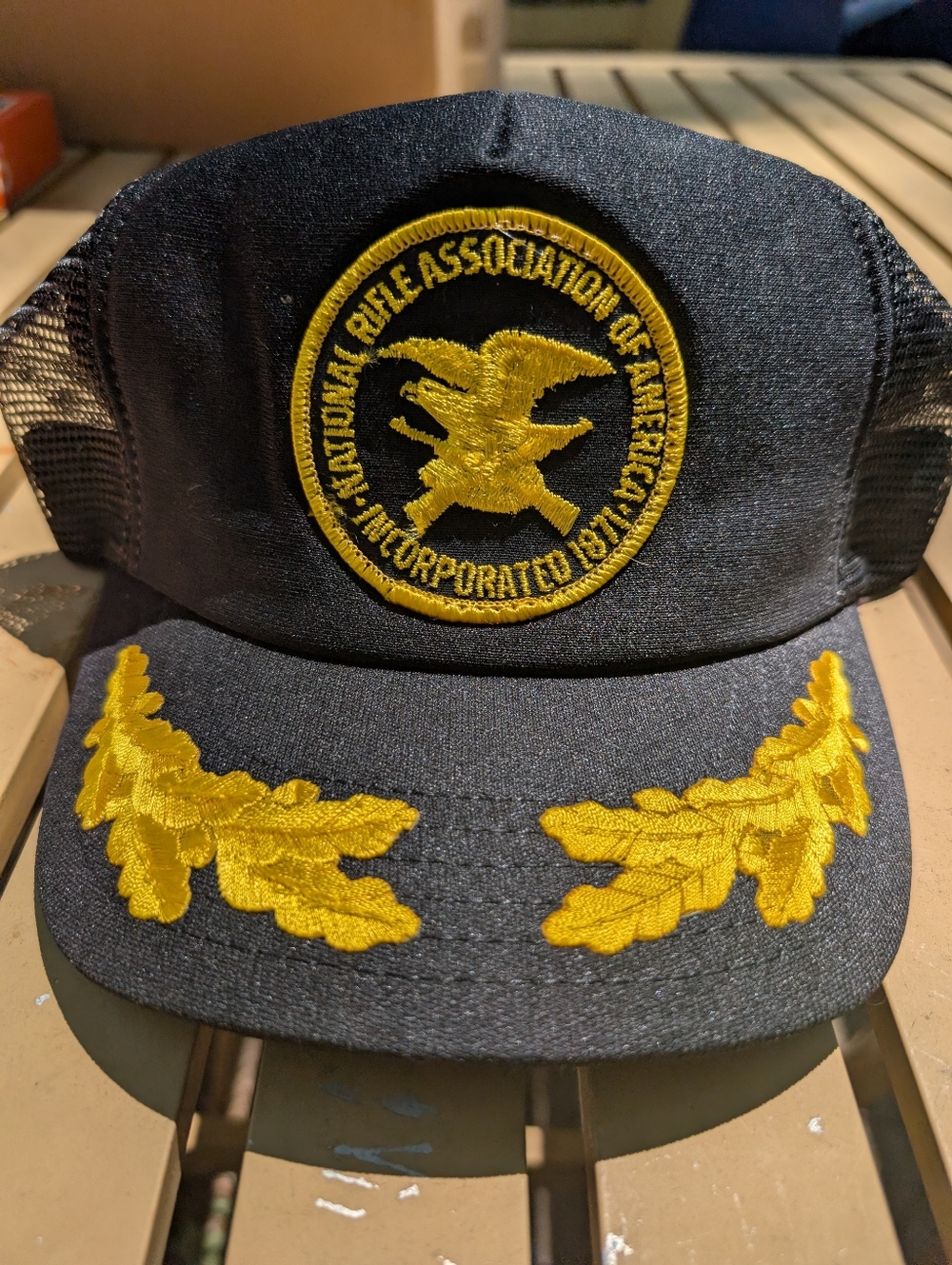 NRA Embroidered Trucker Hat in Black and Gold